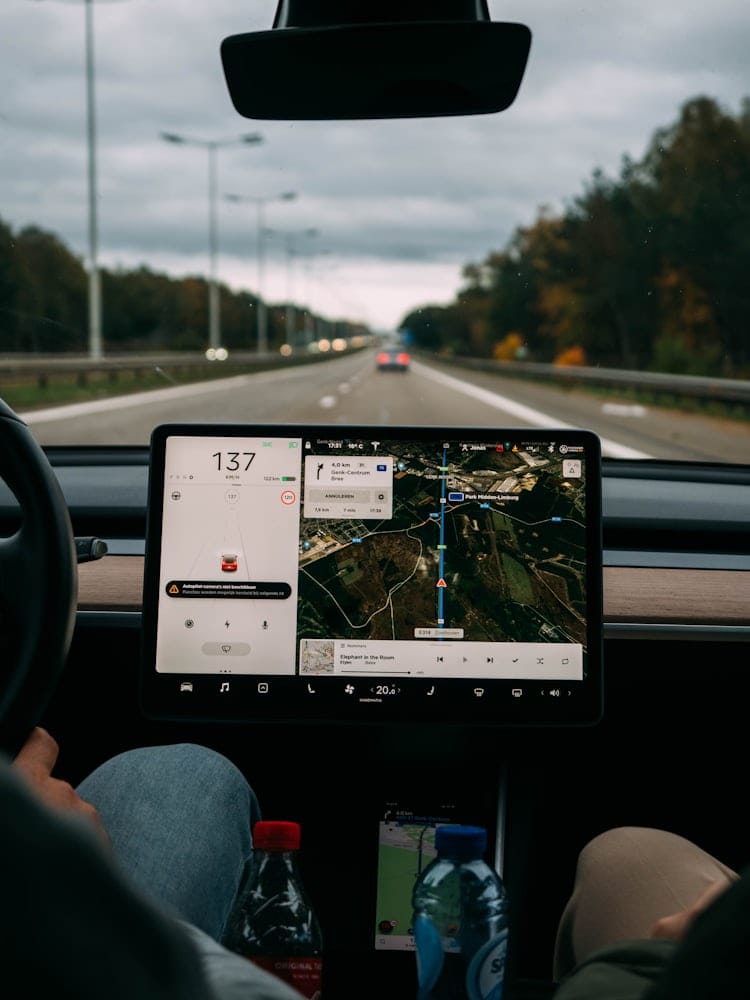 In-vehicle dashboard screen showing a live map and speed